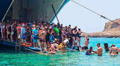 A Creta niente molo, turisti costretti a entrare in acqua con i bagagli sulla testa  per sbarcare o salire a bordo dei traghetti – Il video 